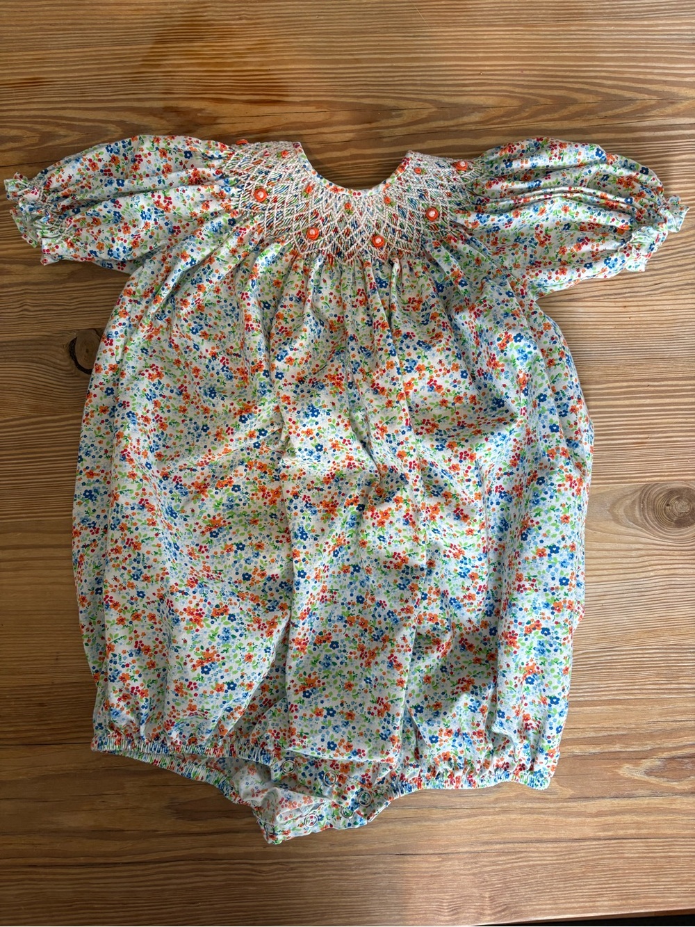 Smocked Floral Baby One-Piece Romper in White with Orange Accents